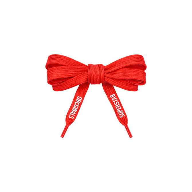 A red bow made from custom shoe laces, featuring tips with printed text.