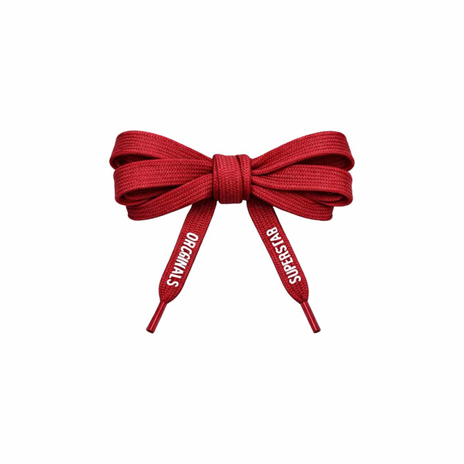 A set of red custom shoelaces tied in a bow, featuring branding on the ends.