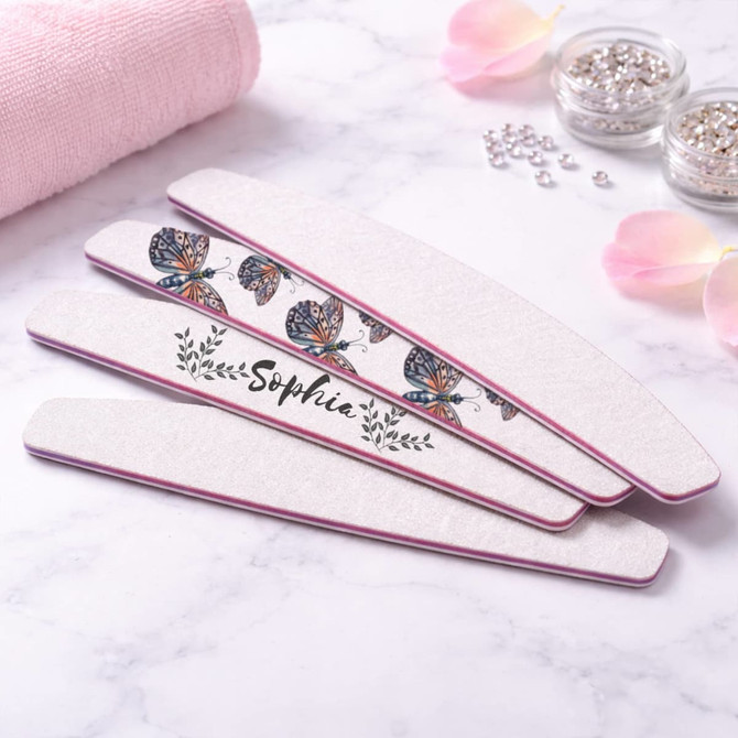 A set of half moon shaped nail files featuring a butterfly design and a personalised name, with a pink trim.