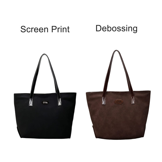 Two suede leather tote bags in black and brown, each featuring a logo. One has a screen print, the other debossing.