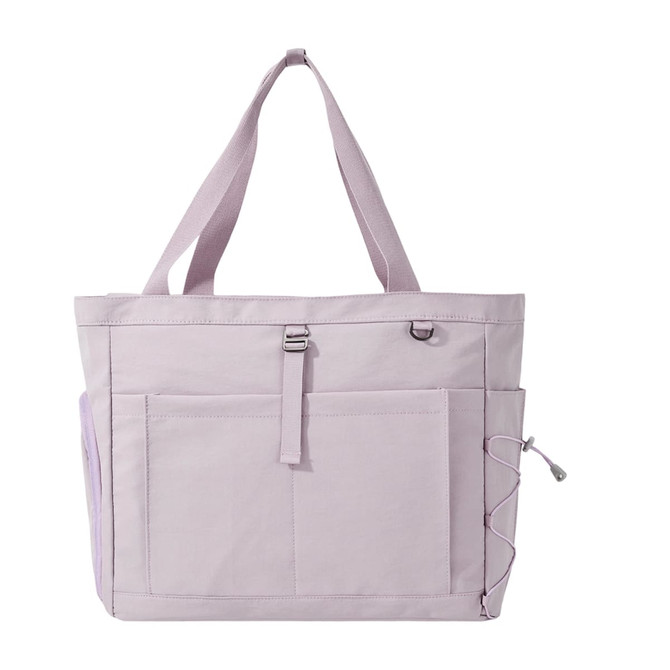 A lightweight tote bag in soft lavender with multiple pockets and a strap. Features a simple logo on the front.