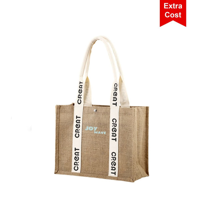 A jute tote bag in natural tones with cream handles and a logo. Features decorative straps with text.