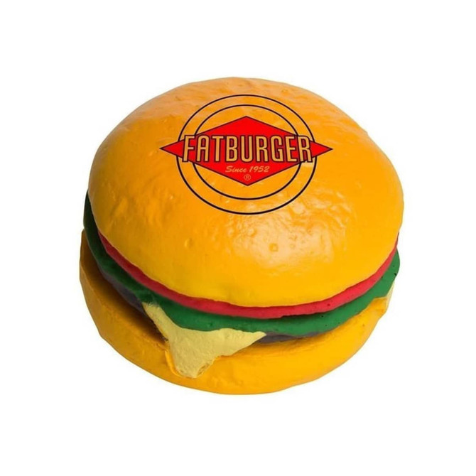 A yellow hamburger-shaped stress reliever with red, green, and yellow details, featuring a logo on top.
