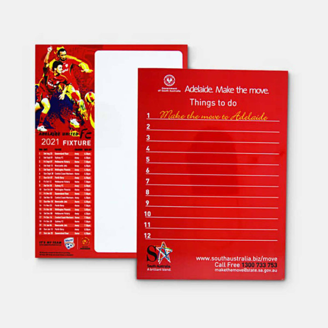 A red magnetic whiteboard featuring a grid layout and a branding logo on one side, and a list on the other.