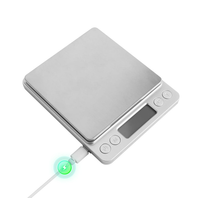 A stainless steel rechargeable kitchen scale with a digital display and charging cable connected.