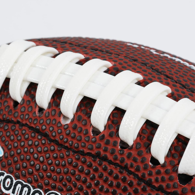 A mini promotional American football in red and white, featuring textured detailing and a logo.
