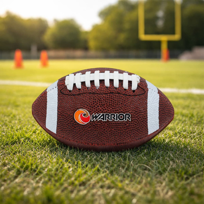 A mini promotional American football in brown with white stripes, featuring a logo, on a grassy field.
