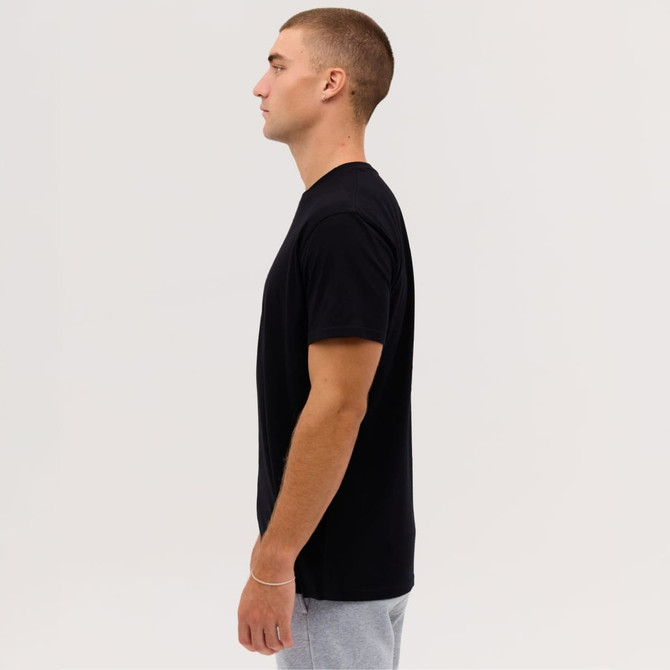 A plain black T-shirt on a male model shown in profile against a neutral background. It has a logo on the sleeve.