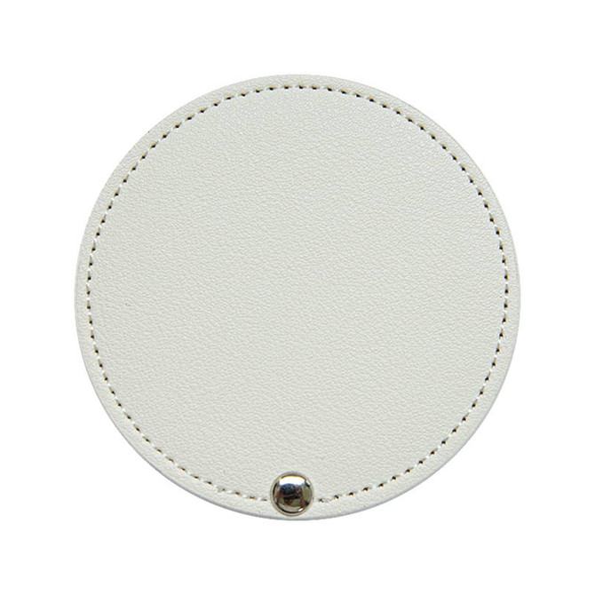A round white makeup mirror with a textured surface and a small silver button detail. It has a subtle stitching around the edge.