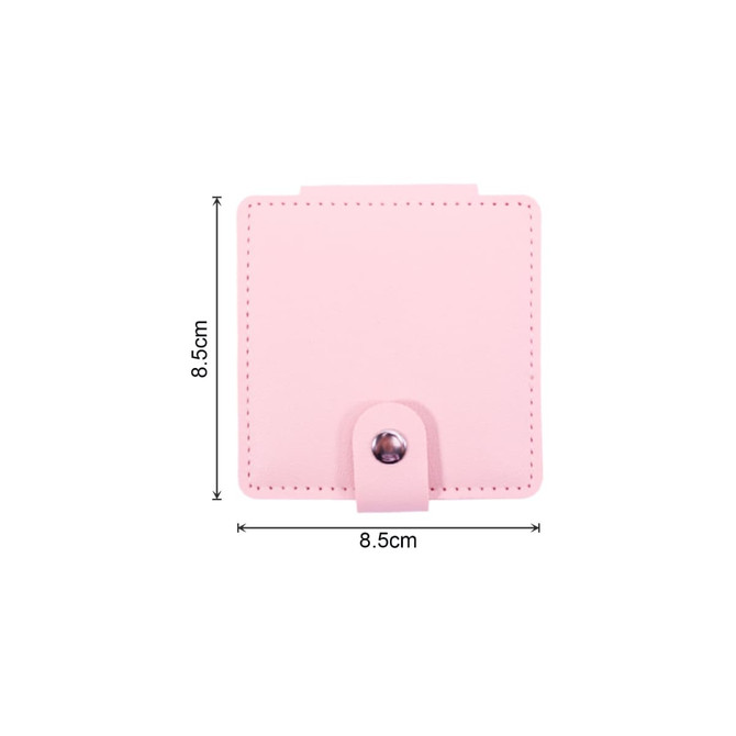 A pink square folding pocket mirror with a snap closure, featuring dimensions of 8.5 cm by 8.5 cm.