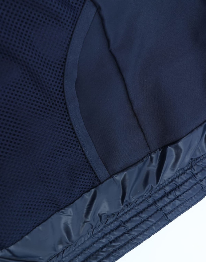 A navy kids' sustainable lightweight hooded puffer jacket featuring a textured interior and smooth exterior finish, with a logo.