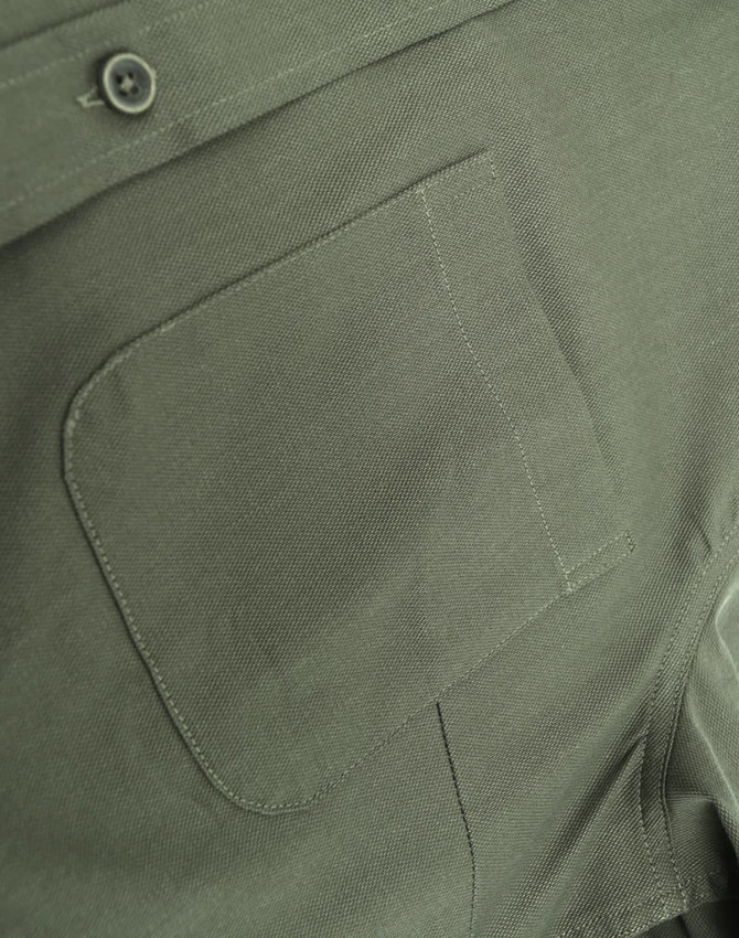 An olive green cotton blend shirt features a button-down collar and a chest pocket. It includes a logo.
