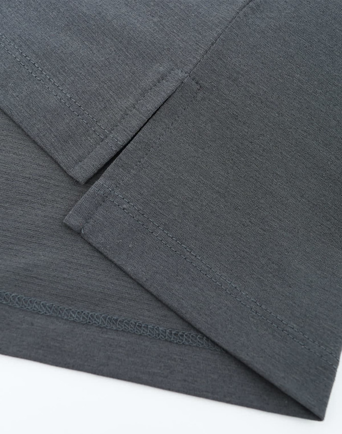 A high-performance grey polo with a smooth texture and a logo. Features short sleeves and fine stitching details.