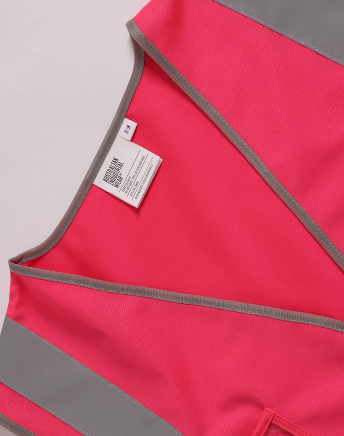 A pink high visibility safety vest featuring grey accents and utility pockets. It includes a space for ID and has a logo.