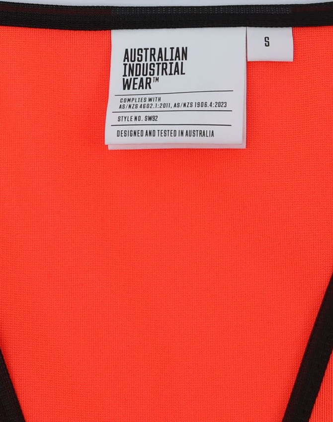 A vibrant orange safety vest with black trim and a tag indicating size and brand details, featuring a logo.