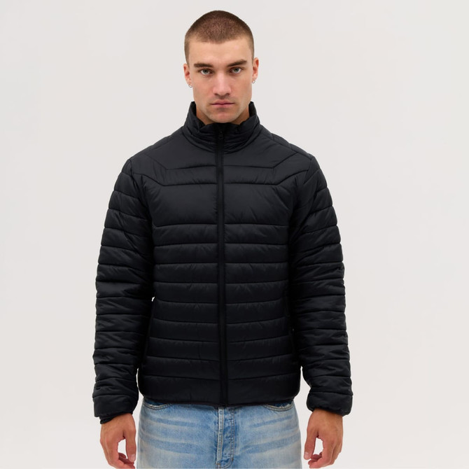 A puffer jacket in black, featuring a zip front and a stand collar, worn by a model.