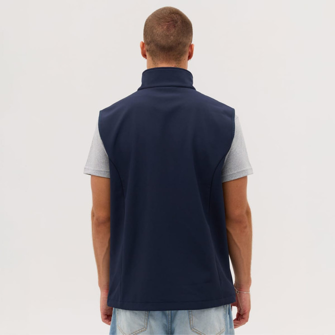 A navy softshell vest is displayed on a model from the back, featuring a high collar and no visible logos.