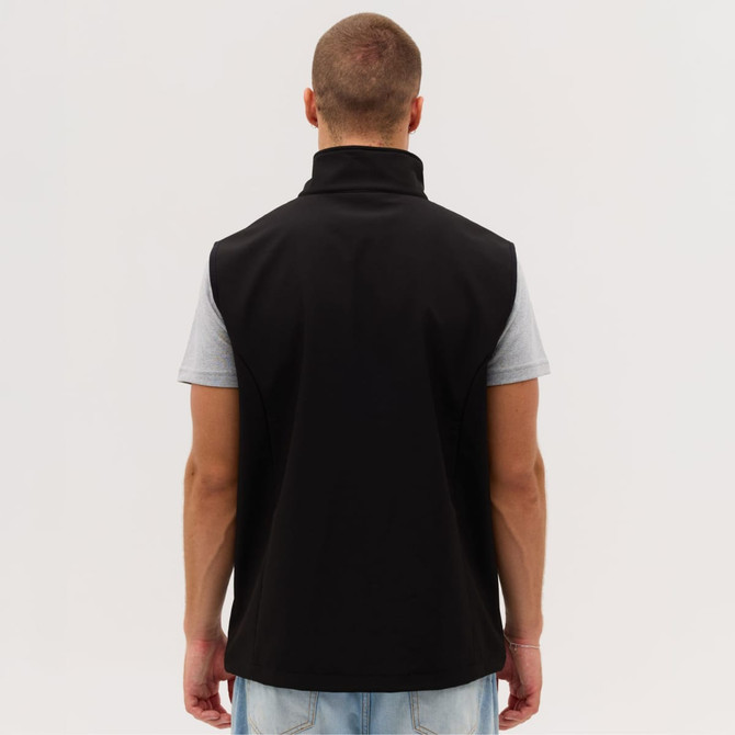 A black softshell vest is displayed, featuring a high collar and a sleek design, with a person wearing it from the back.