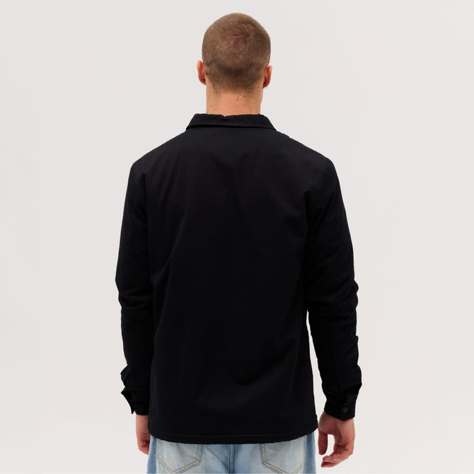 A black Studio Canvas Jacket displayed from the back, featuring a simple design and long sleeves.