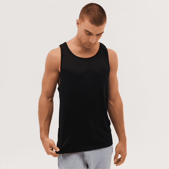 A black singlet featuring wide armholes and a logo, worn by a male model in a neutral setting.
