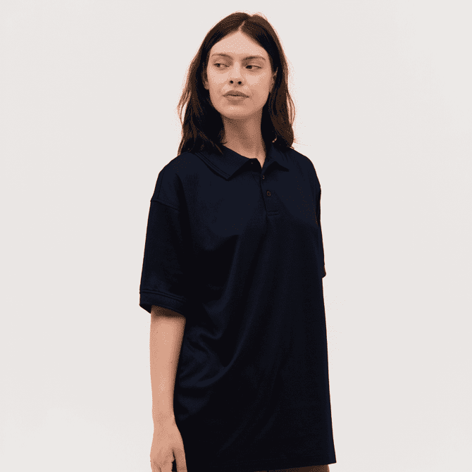 A navy blue polo shirt with a relaxed fit, featuring a collar and buttons, modelled by a person.