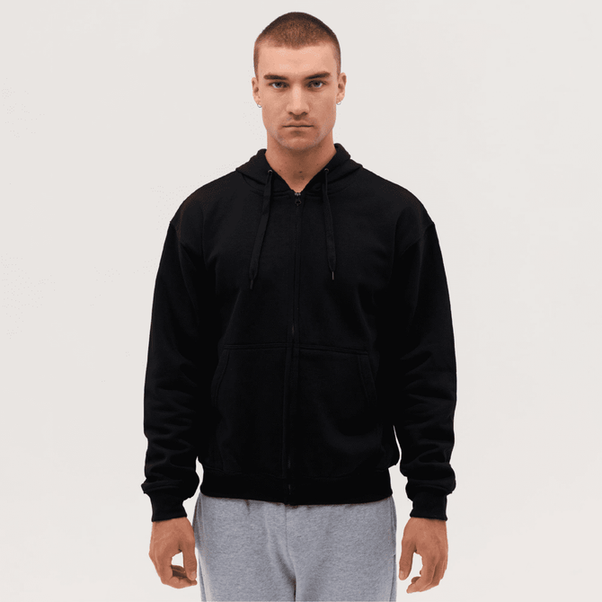 A black zip-up hooded sweatshirt on a model, featuring a front zipper and drawstring hood.