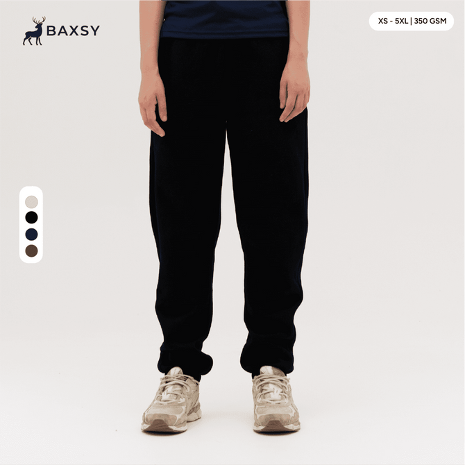 Black track pants displayed on a person, featuring a casual fit and an elastic waistband, with a logo visible.