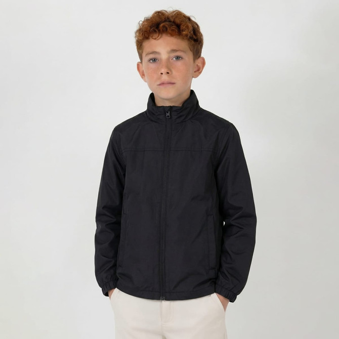 A youth weather jacket in black, featuring a zip front and a stand-up collar. The model has curly, reddish-brown hair.
