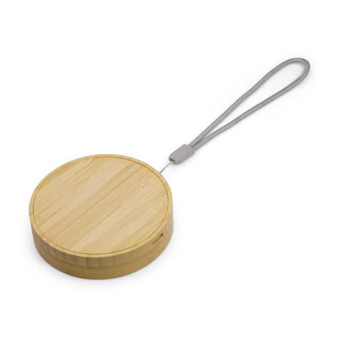 A round bamboo wireless charger with a grey attached strap. The surface is smooth and natural in colour.