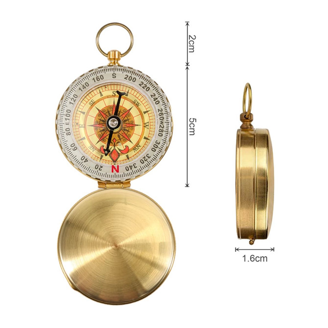 A brass compass with a decorative dial, featuring a magnifying glass and a ring for attachment, measuring 5cm by 2cm.