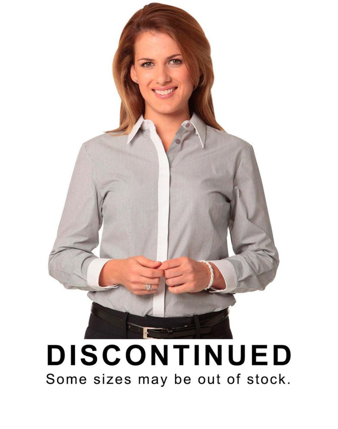 A woman wearing a grey and white striped long sleeve shirt with a white collar. The shirt has a logo on it.