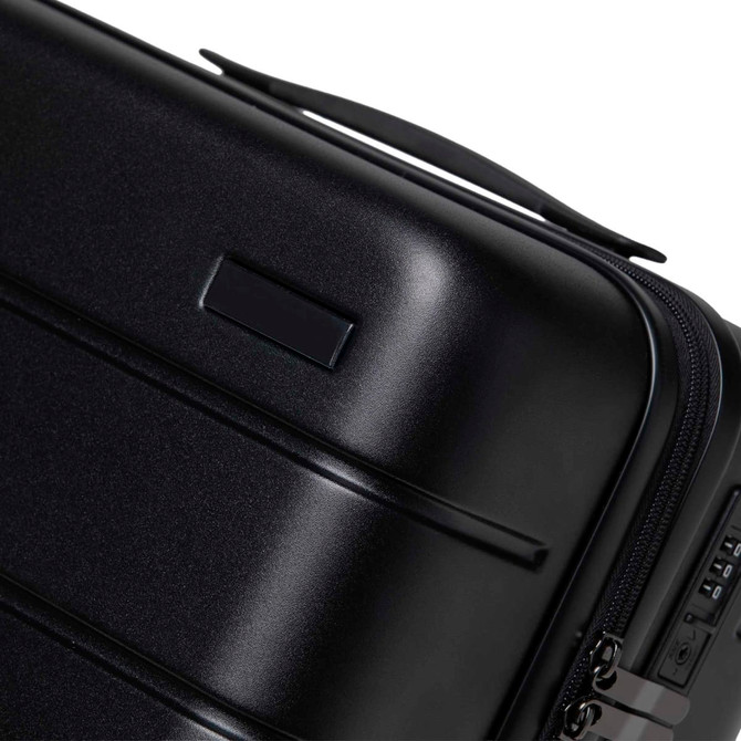 A black hardcase trolley with a smooth finish and a handle, featuring a zip closure and a small branding area.