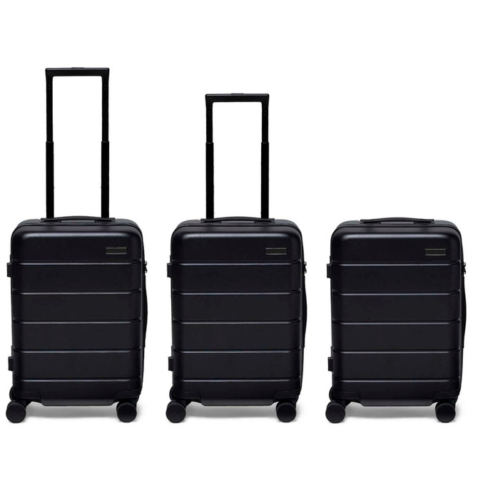 Three black hardcase suitcases with extendable handles and wheels, featuring a logo on the front.