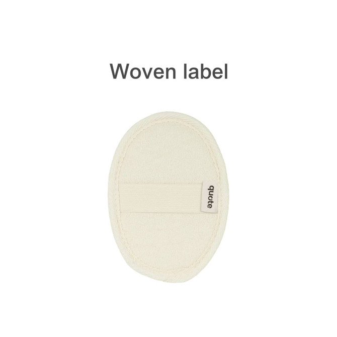 A natural cotton linen bath sponge pad in a cream colour with a woven label attached.