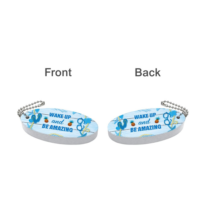 A blue oval keychain features tropical designs with a silver chain. Both sides display the same motivational text and graphics.