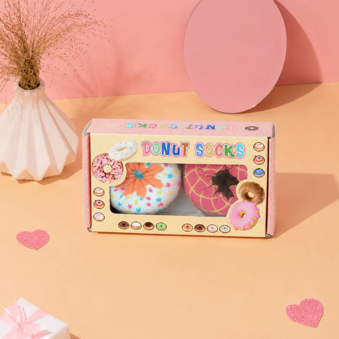 A medium custom gift box with a rectangular window displays colourful donut socks in pastel shades. The box features a logo.