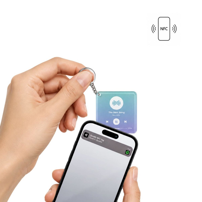 An NFC acrylic keychain in gradient blue and purple design, held next to a smartphone, showcasing a logo.