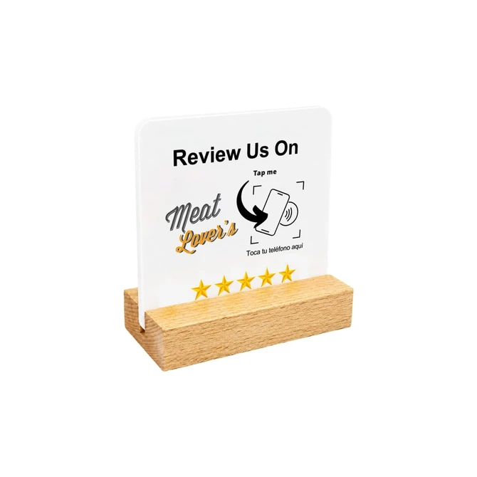 A NFC acrylic menu in clear with a wooden stand, featuring a logo and icons for mobile interaction.