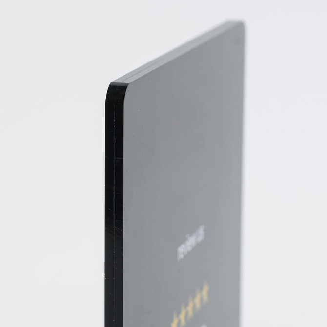 A sleek black acrylic menu stand with a smooth edge and glossy finish, featuring a branding logo.