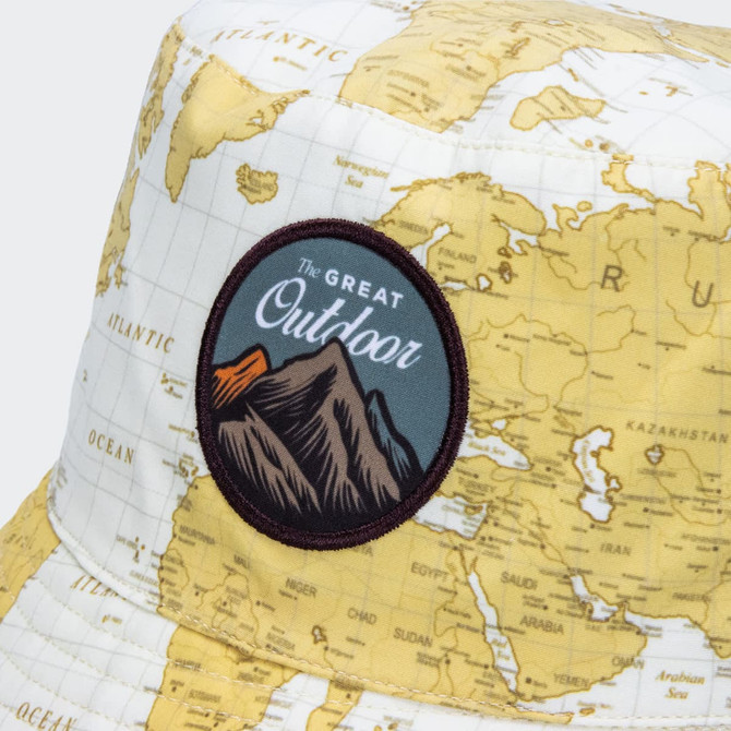 A bucket hat with a map design in yellow and a patch featuring mountains and the phrase "The Great Outdoor".