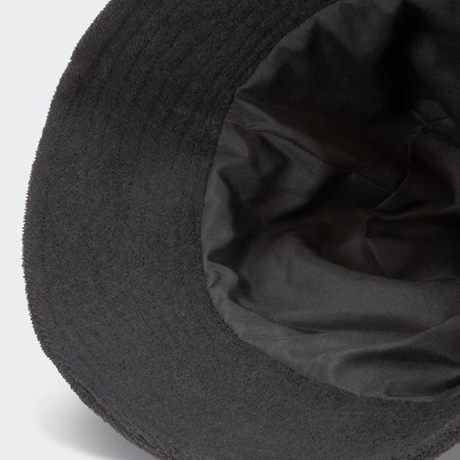 A black terry towelling bucket hat featuring a soft inner lining and a logo.