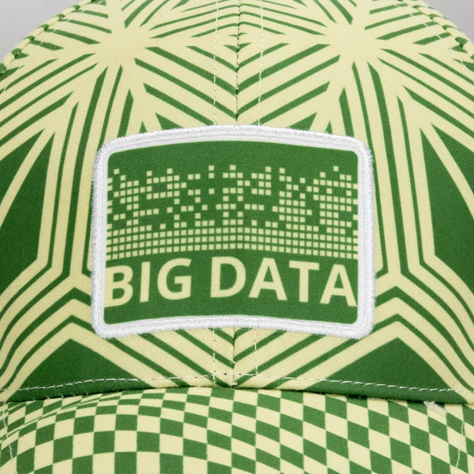 A cap featuring a green and yellow geometric pattern with a patch. The cap has a logo on the front.
