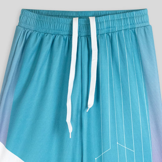 Custom youth active pants in gradient shades of blue with white drawstrings and a geometric pattern.