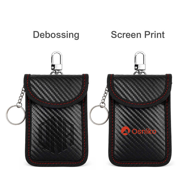 A black carbon fibre Faraday key pouch with red stitching, featuring a clasp and a keyring. It has a logo displayed.