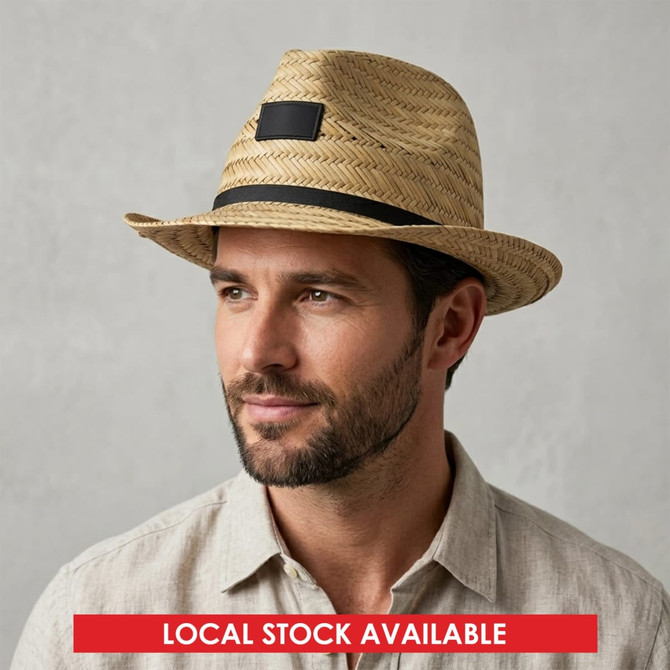 A Panama straw hat in natural tones with a black ribbon band, featuring a logo on the front.