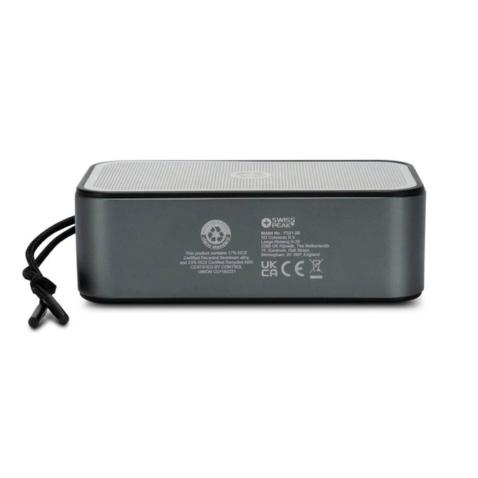 A grey Bluetooth speaker with a mesh top and a side strap, featuring branding and various technical labels on the back.