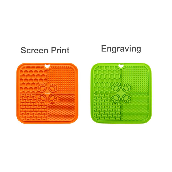 A 4-section dog enrichment lick mat in orange and green, featuring textured surfaces and a small hole for hanging.