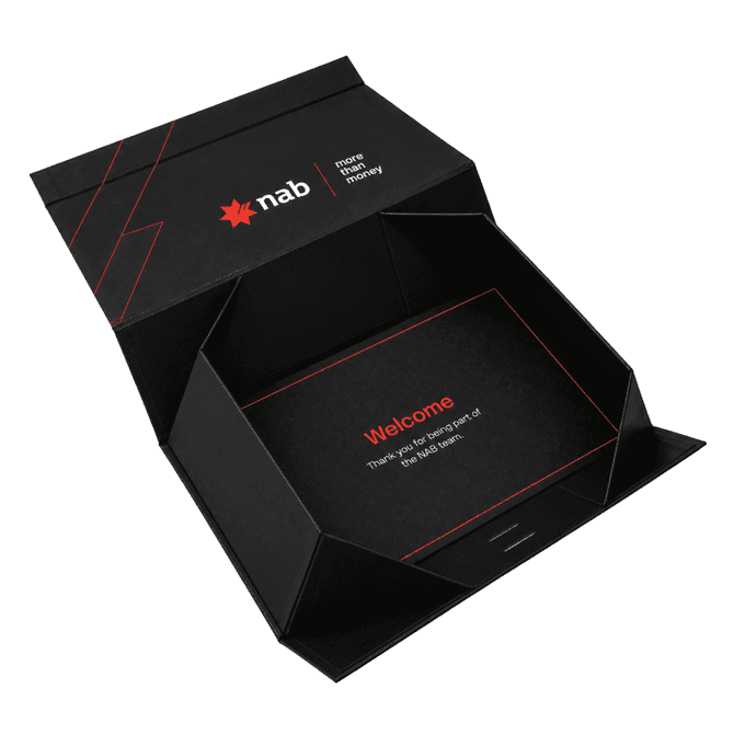 A small black gift box with red accents and an internal greeting message. It features a logo and a ribbon.