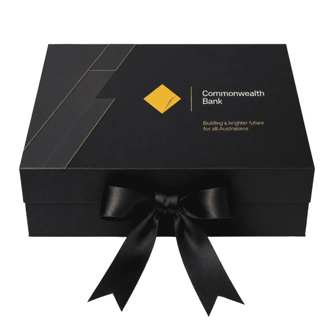 A large black gift box with a ribbon, featuring a logo and modern design elements.