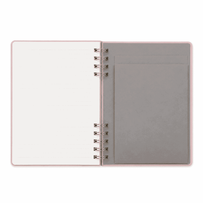 A Twin-Spiral PU hardcover notebook featuring lined pages and a grey pocket on the inside cover, with a soft pink exterior.
